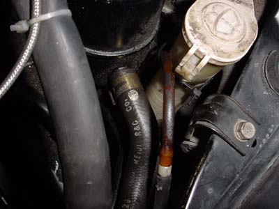 Re-routed windshield washer hose